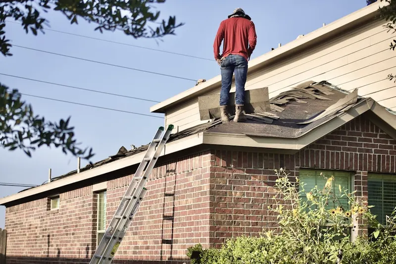 Professional roofer working on a residential roof in Far Greater Northside